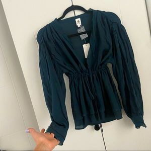 Bran new with tags, long sleeve adjustable waste draw string blouse. V neck